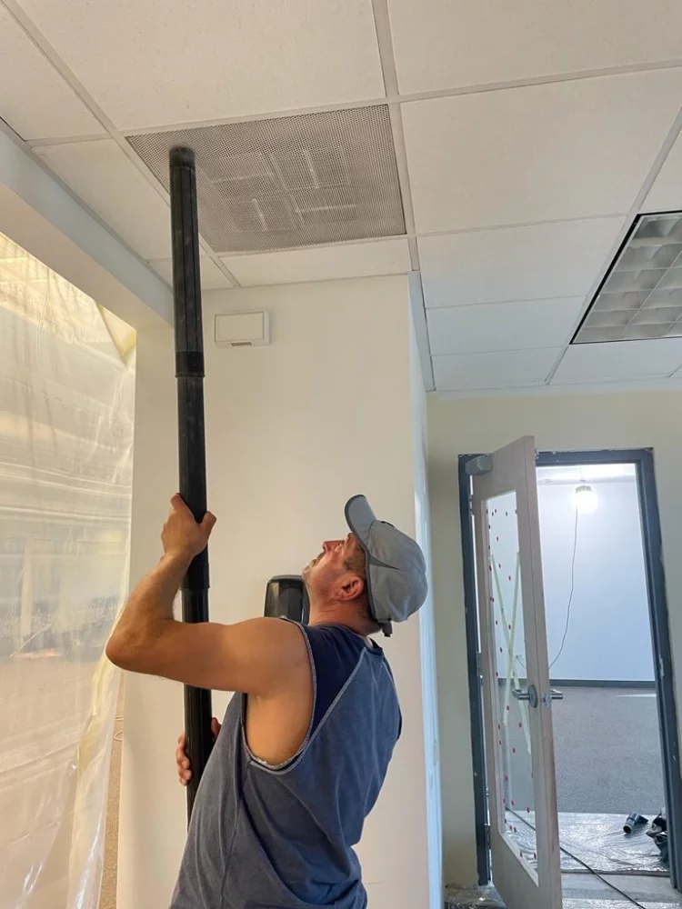male cleaning ceiling
