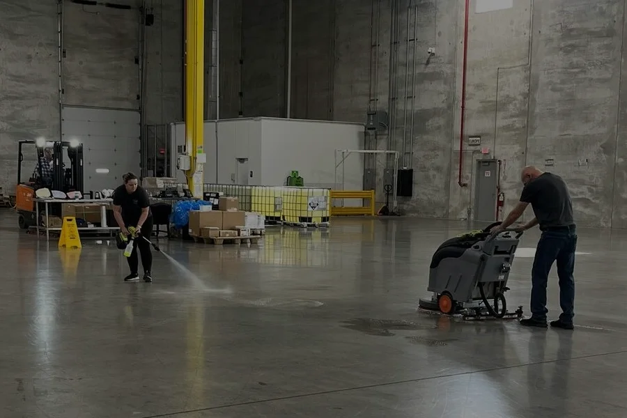 industrial walk behind and ride on floor scrubbers in warehouse